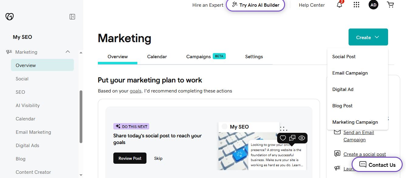 GoDaddy Marketing dashboard with a Create menu listing social post, email campaign, and digital ad options
